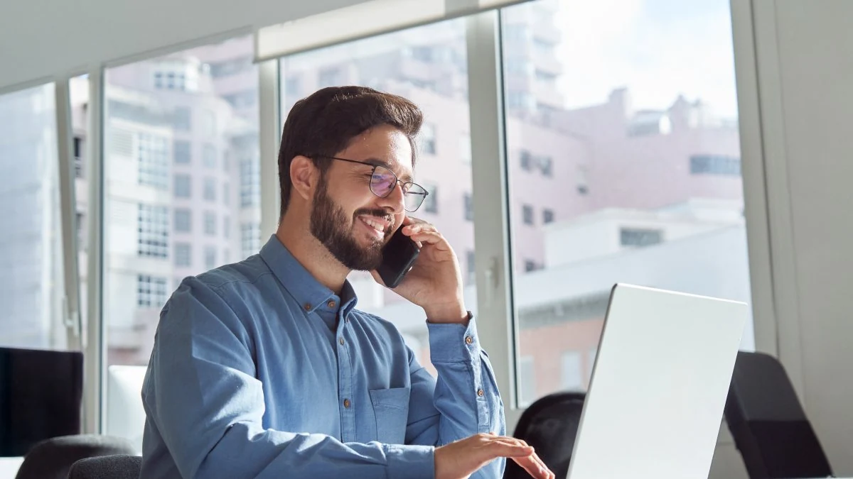 Sales rep making a cold call from his desk