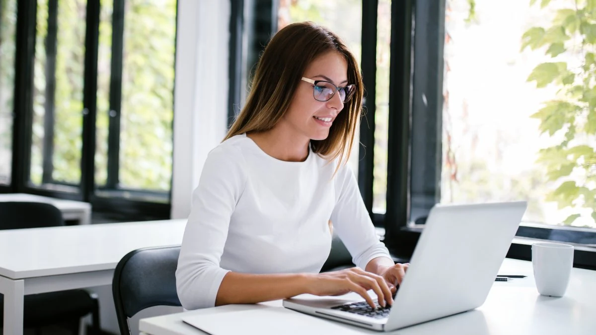 Sales rep reviewing performance data at her laptop