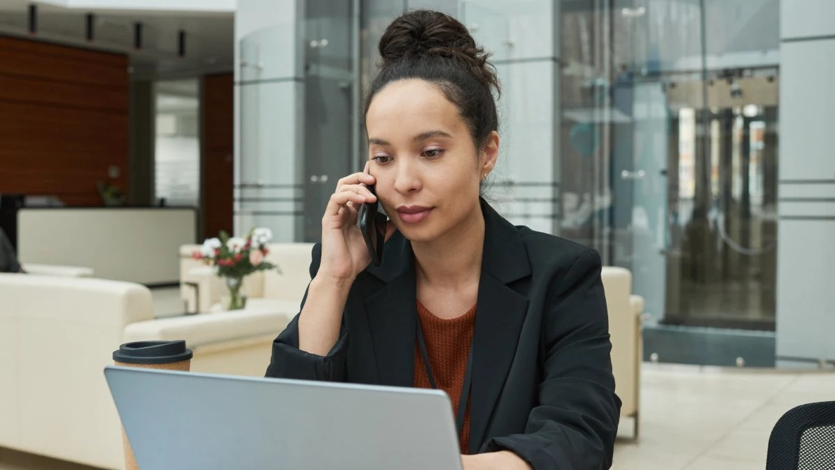 Insurance agent on a client call at her laptop