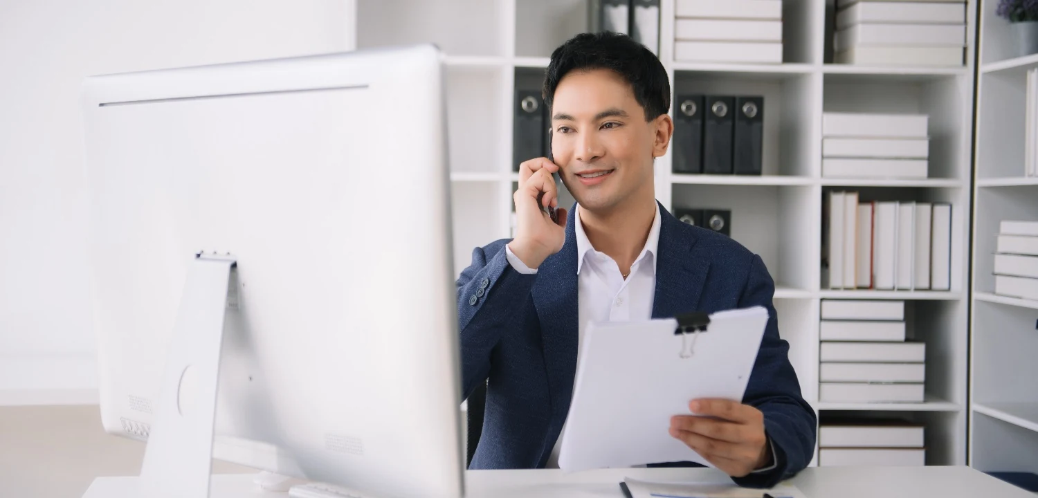 Sales rep wearing a headset practicing a conversation at a laptop with AI coaching interface on screen