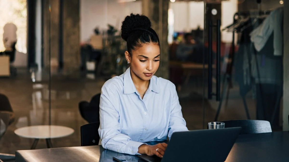 Sales manager working at a laptop in a modern office